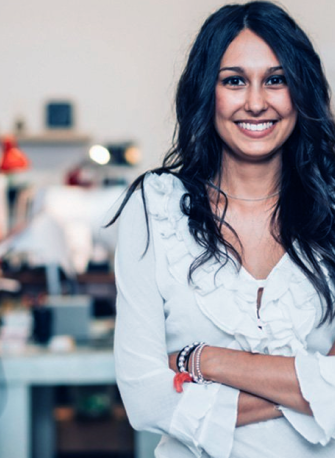 woman smiling, with her arms crossed